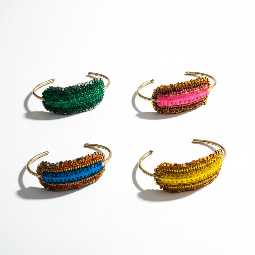 Four colorful beaded headbands on a gray surface