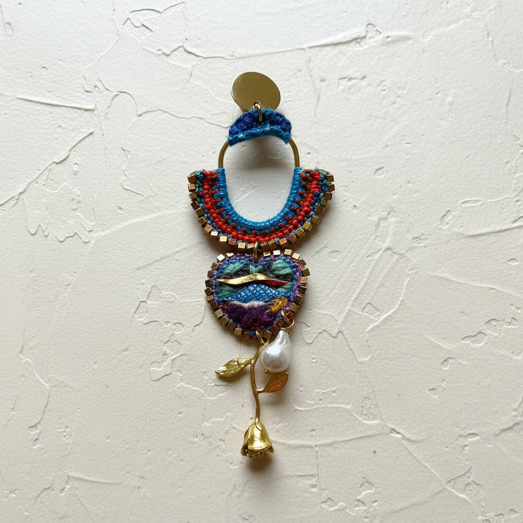 Colorful macrame earring with floral design on a textured white background