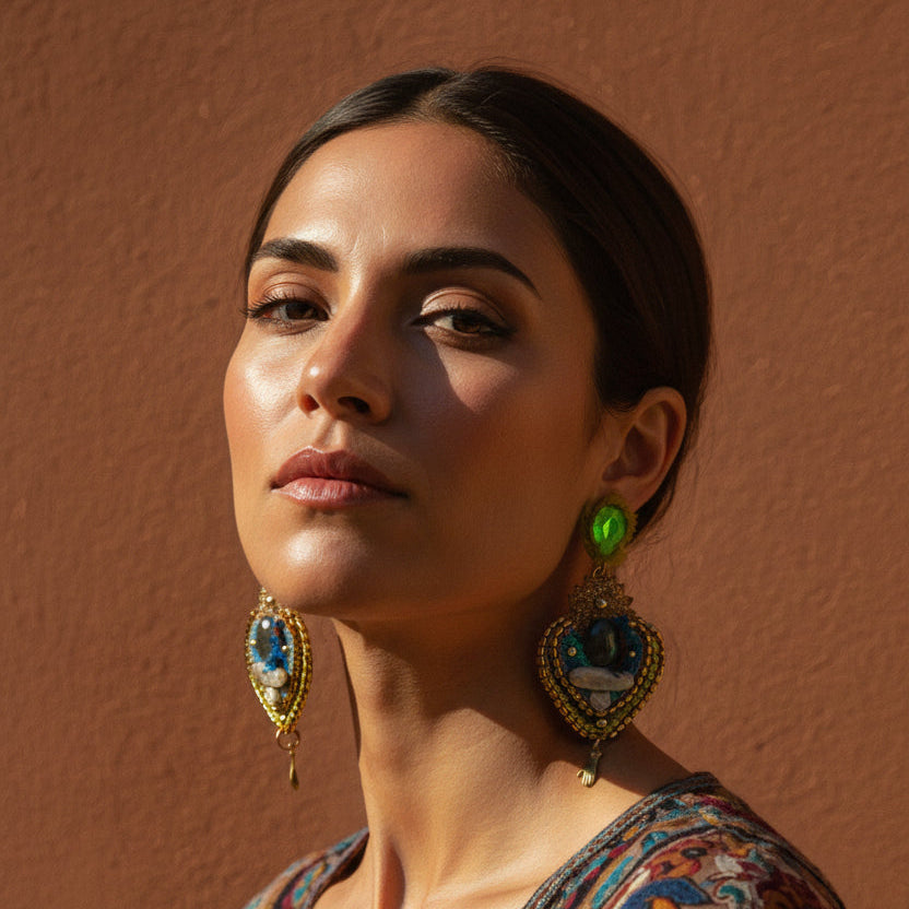 Woman wearing colorful earrings against a brown background