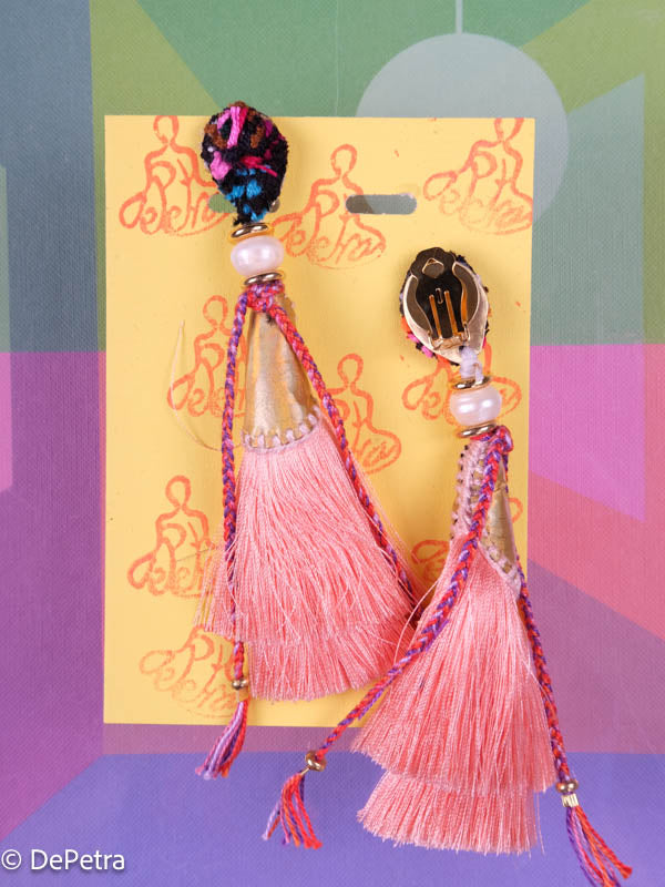 A whimsical and playful pair of earrings feature a long silk tassel. They are made of high-quality materials and are sure to turn heads wherever you go.