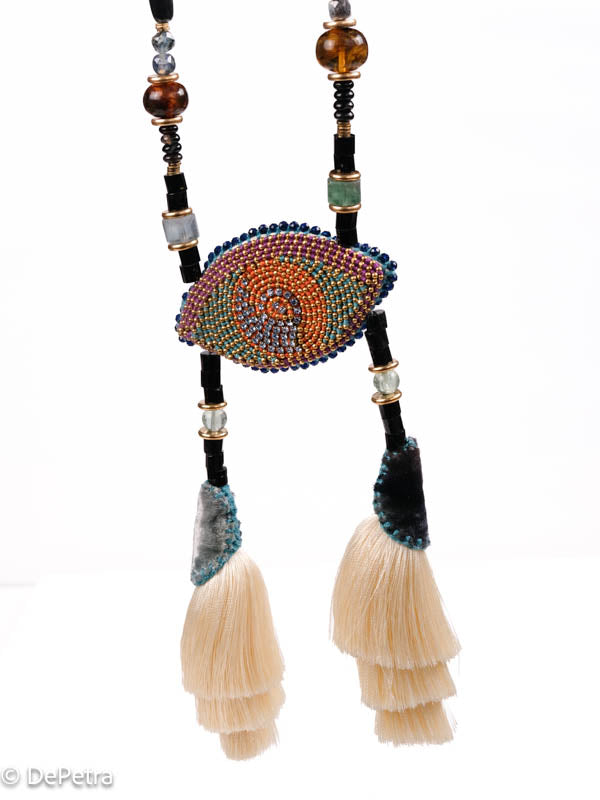 I wear my handmade necklace with tassels and a cosmic eye with blue vintage Swarovskis that made a blue reflection as a reminder of the beauty of the universe.