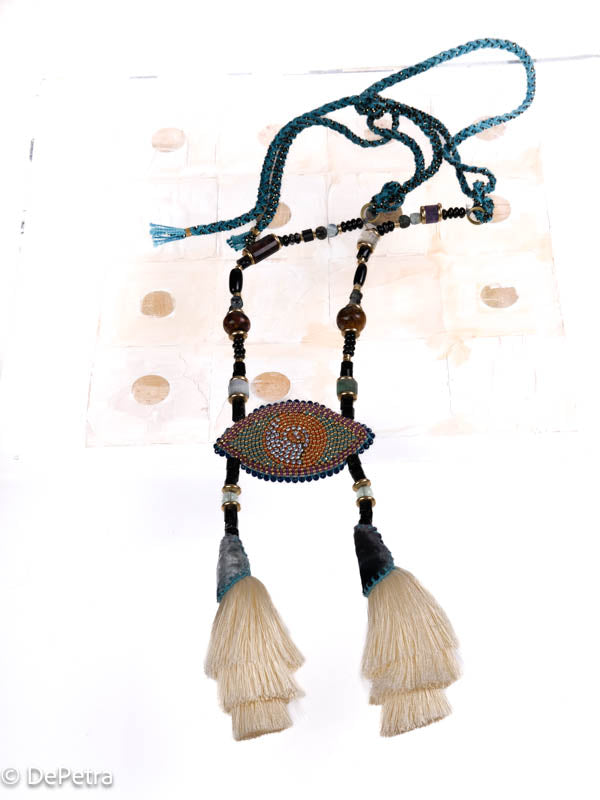 I wear my handmade necklace with tassels and a cosmic eye with blue vintage Swarovskis that made a blue reflection as a reminder of the beauty of the universe.