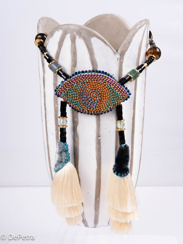 I wear my handmade necklace with tassels and a cosmic eye with blue vintage Swarovskis that made a blue reflection as a reminder of the beauty of the universe.