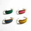 Four colorful beaded headbands on a gray surface