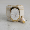 Ring with a Cameo design and pearl accent on a white background
