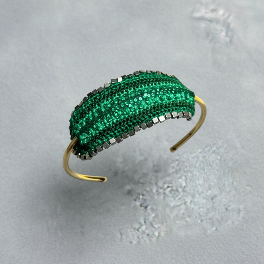 Green beaded headband on a gray surface
