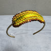 Colorful woven headband on a gray background