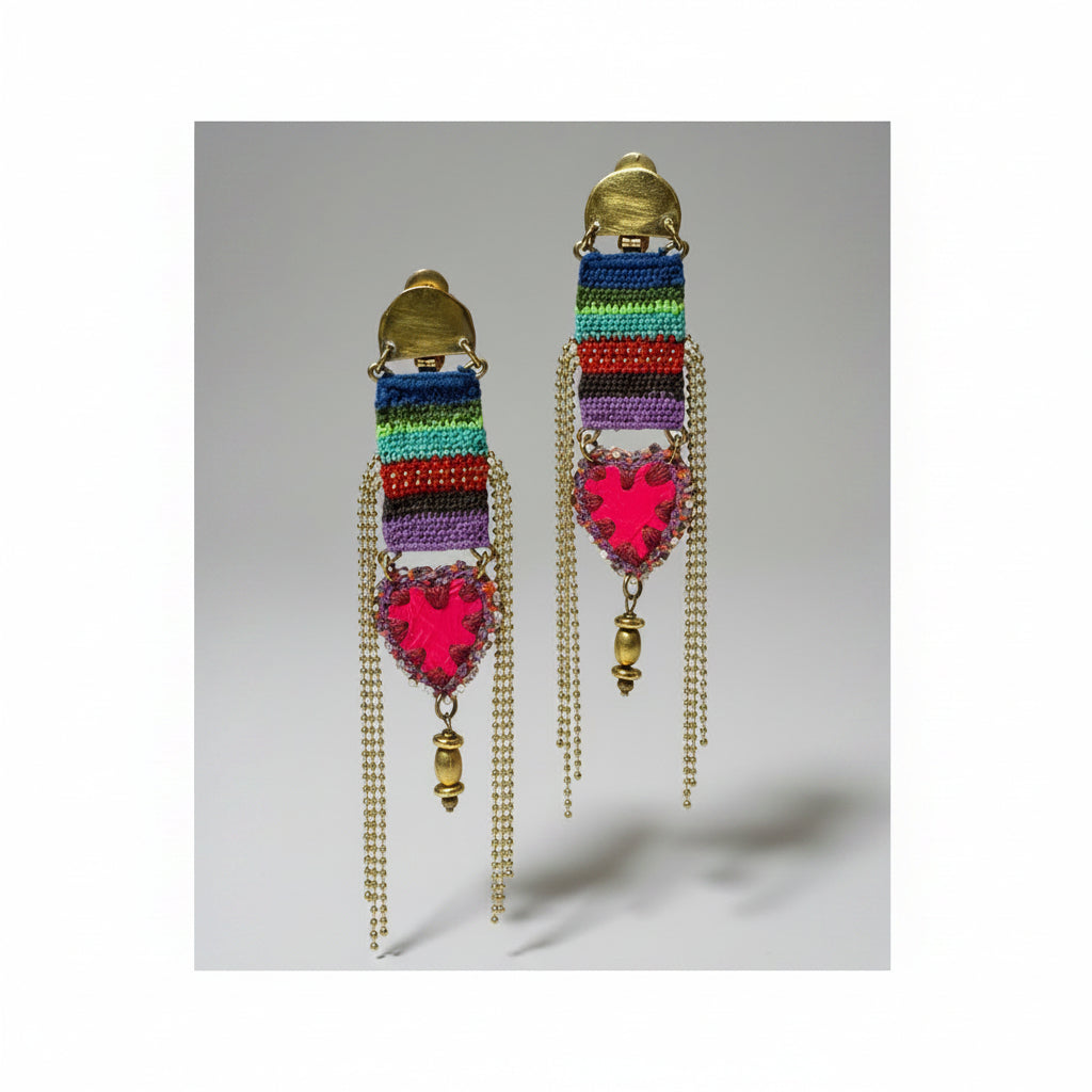 Colorful macramé earrings with heart-shaped charms on a black background