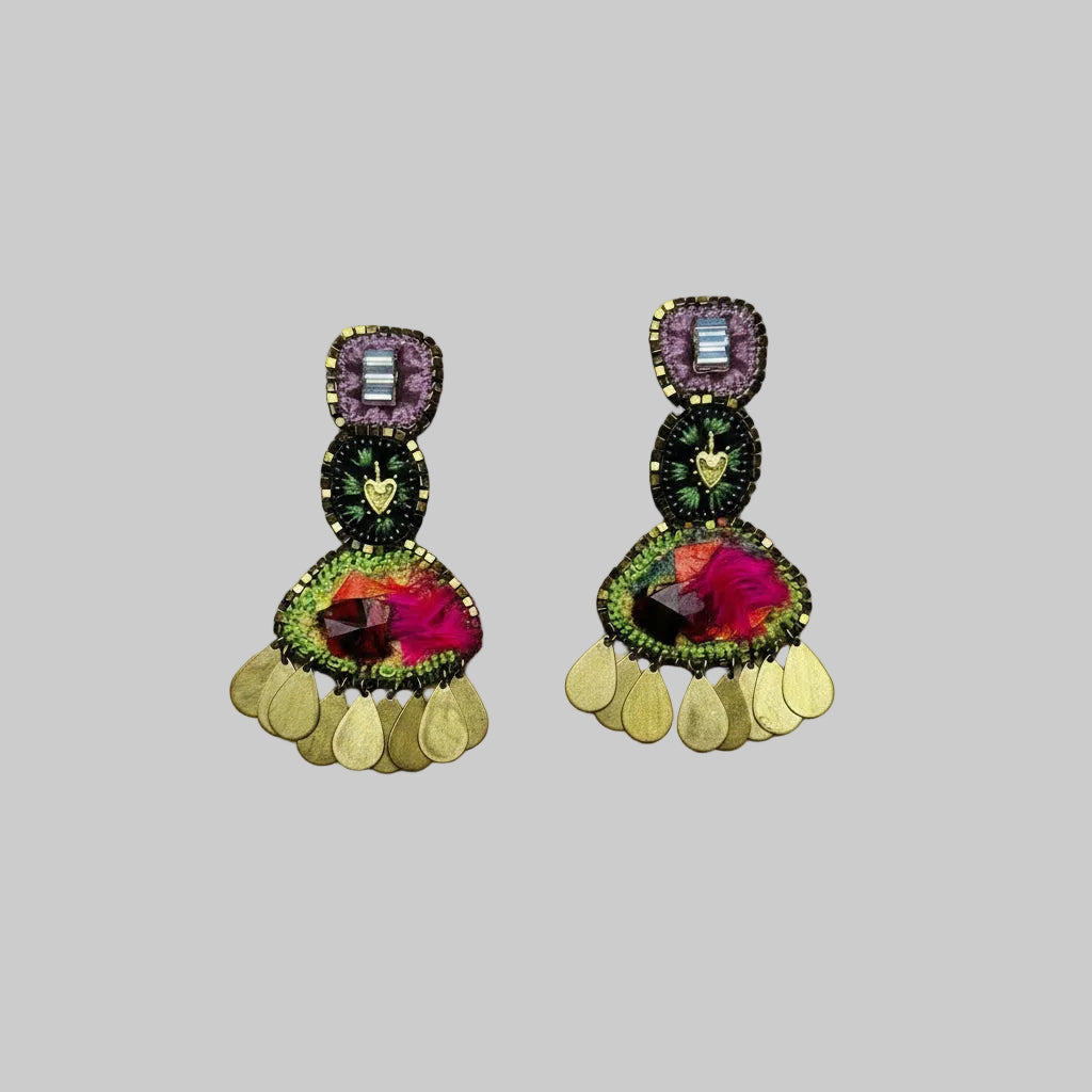 Colorful earrings with floral and circular designs on a gray background