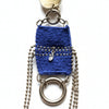 Blue woven keychain with metal rings and a tag on a textured gray background