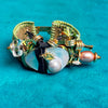 Decorative bracelet with pearls and beads on a turquoise background