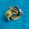 Decorative ring with intricate design on a blue background