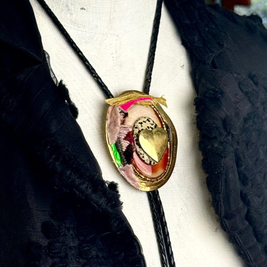 Bolo tie with decorative pendant on a mannequin bust