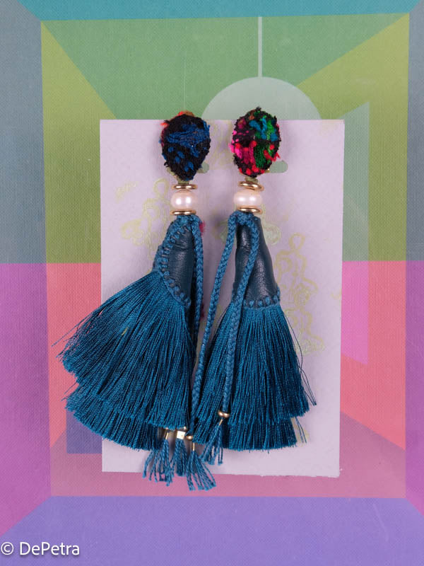 A whimsical and playful pair of earrings feature a long silk tassel. They are made of high-quality materials and are sure to turn heads wherever you go.