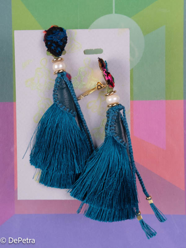 A whimsical and playful pair of earrings feature a long silk tassel. They are made of high-quality materials and are sure to turn heads wherever you go.