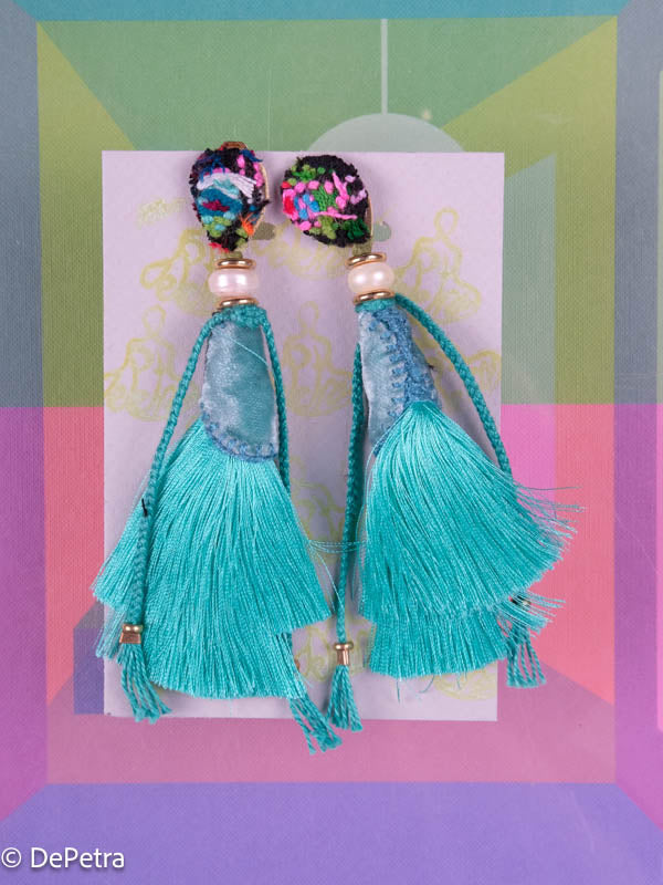 A whimsical and playful pair of earrings feature a long silk tassel. They are made of high-quality materials and are sure to turn heads wherever you go.