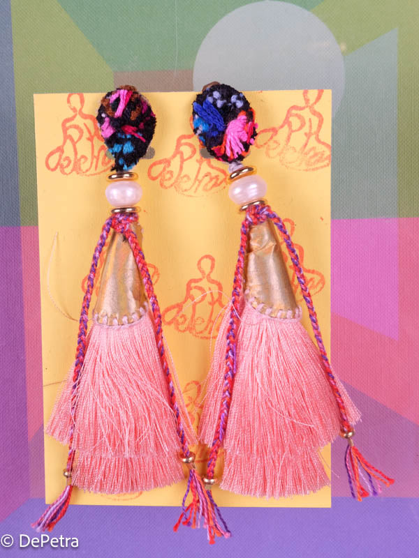 A whimsical and playful pair of earrings feature a long silk tassel. They are made of high-quality materials and are sure to turn heads wherever you go.