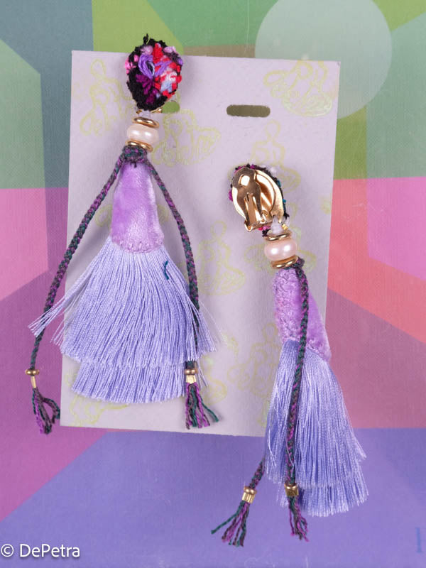 A whimsical and playful pair of earrings feature a long silk tassel. They are made of high-quality materials and are sure to turn heads wherever you go.