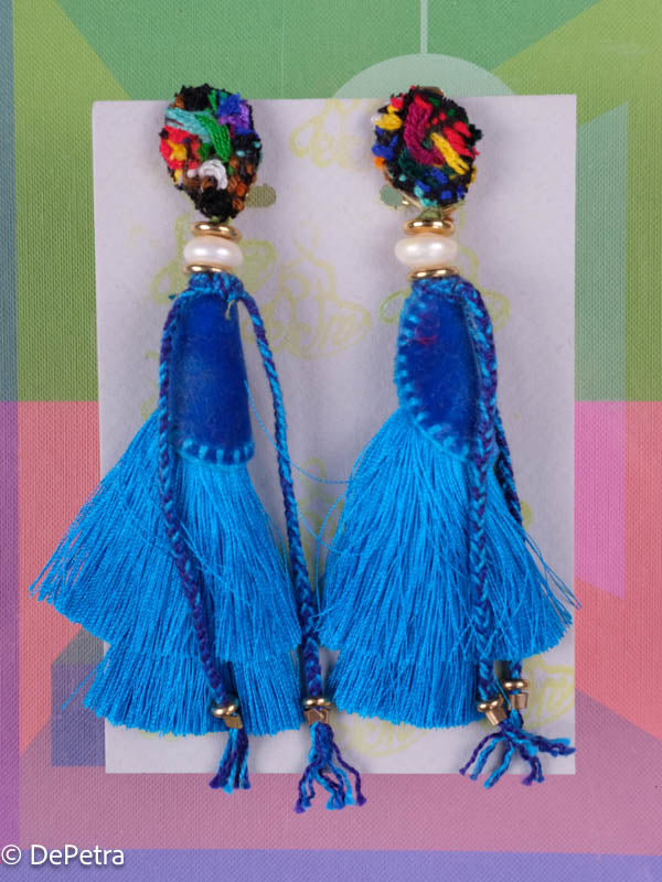 A whimsical and playful pair of earrings feature a long silk tassel. They are made of high-quality materials and are sure to turn heads wherever you go.