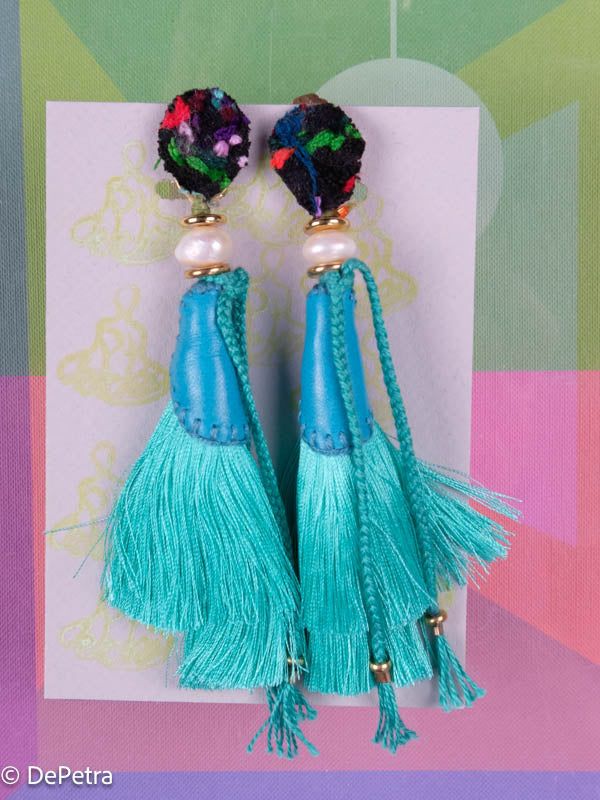 A whimsical and playful pair of earrings feature a long silk tassel. They are made of high-quality materials and are sure to turn heads wherever you go.