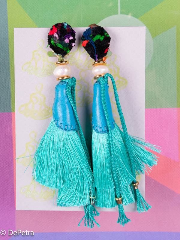 A whimsical and playful pair of earrings feature a long silk tassel. They are made of high-quality materials and are sure to turn heads wherever you go.