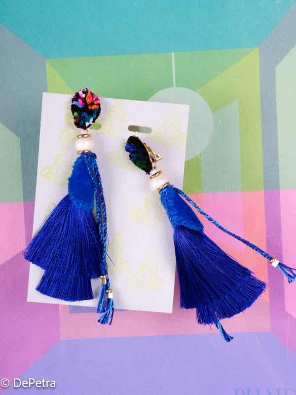 A whimsical and playful pair of earrings feature a long silk tassel. They are made of high-quality materials and are sure to turn heads wherever you go.