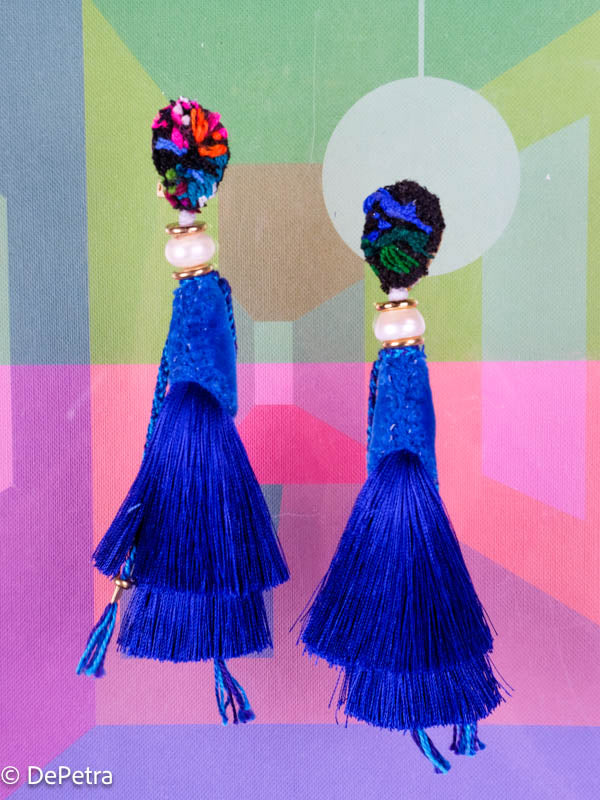 A whimsical and playful pair of earrings feature a long silk tassel. They are made of high-quality materials and are sure to turn heads wherever you go.